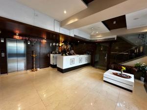a lobby with a bar in a building at South Coast Hotel Wagle Estate Thane in Thane
