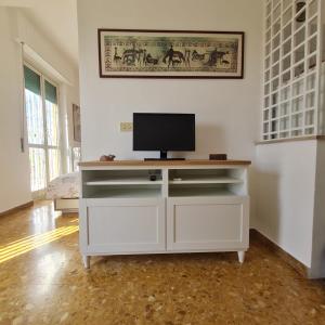 a white entertainment center with a television on top of it at L' attichetto in Rome