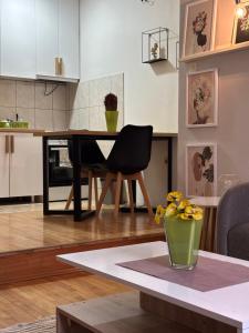 a kitchen and living room with a table and a dining room at Mia’s duplex apartment in Skopje