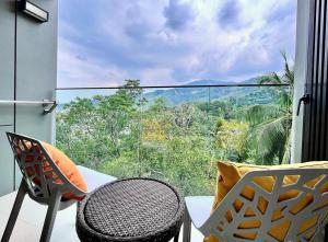 a balcony with a table and chairs and a large window at BnB Homes Modern Sea Breeze apartment with 6 Swimming Pools & Restaurants in Surin Beach +33 photos
