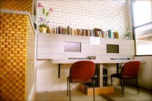 a desk with two chairs and a desk with books at Beringgis Beach Resort & Spa in Papar