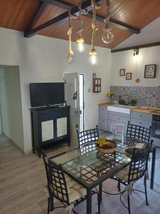 a kitchen with a table with chairs and a television at Casa Amalia in Agulo +21 photos