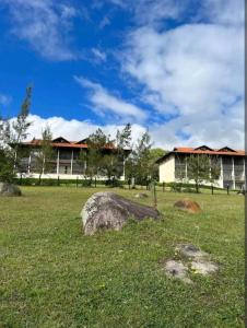 a field with a building and a rock in the grass at FLATS MONTE CASTELO GRAVATÁ CONDOMÍNIO MELHOR LOCALIZAÇÃo in Gravatá +150 photos