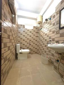 a bathroom with a toilet and a sink at Hotel Royal Central Haridwar in Haridwār