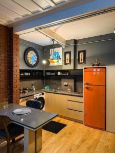 a kitchen with an orange refrigerator and a table at Rent the Entire Bosphorus House in Istanbul