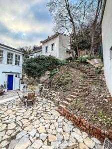 a stone patio with a table and chairs in front of a house at Rent the Entire Bosphorus House in Istanbul