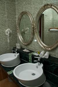 a bathroom with a sink and a mirror at Beringgis Beach Resort & Spa in Papar