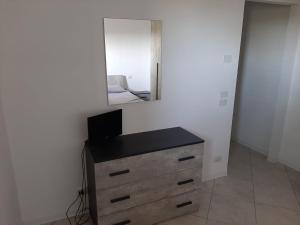 a bedroom with a dresser with a mirror on the wall at Affittacamere Rocca in Montefortino