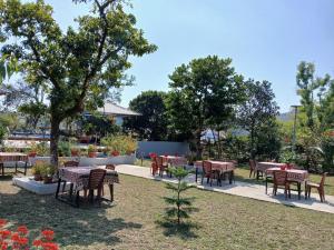 a group of tables and chairs in a park at Catba Papillon Garden Bungalows & Resort in Cat Ba