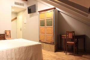 Postel nebo postele na pokoji v ubytování Hostal Siglo XIX