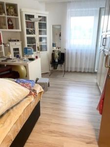 a bedroom with a bed and a desk in a room at EPT Apartments in Schwyz +6 photos