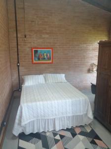圣安东尼奥-杜皮尼亚尔Tutubella的一间带床和砖墙的卧室
