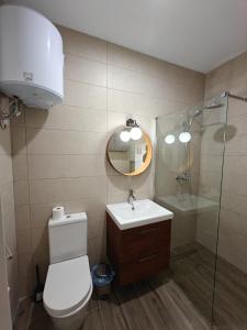 a bathroom with a toilet and a sink and a shower at Spacious Central Apartment in Rabat