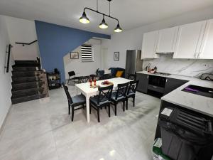 a kitchen and dining room with a table and chairs at Spacious Central Apartment in Rabat