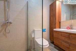 a bathroom with a shower and a toilet and a sink at Spacious Central Apartment in Rabat