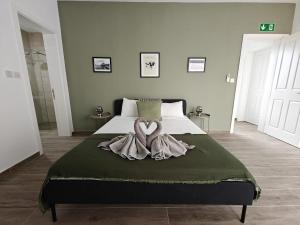 a bedroom with a large bed with a heart decoration on it at Spacious Central Apartment in Rabat