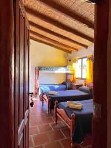 a room with four bunk beds in a room at Hotel La Herencia in Tilcara +15 photos