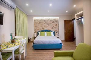 a bedroom with a bed and a table and chairs at TaoZen Apartments in Taormina +37 photos