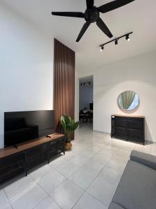 a living room with a couch and a ceiling fan at Rumavin Homestay, Seremban in Seremban