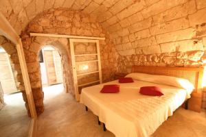Postel nebo postele na pokoji v ubytování trullo macchie