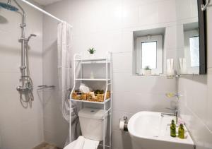 a white bathroom with a toilet and a sink at Stoa House in Mourné +30 photos