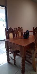 a wooden table with chairs around it with a bowl on it at Vacacional Abril in Juayúa