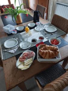a wooden table with food on top of it at Aux Trois Mûriers in Villeneuve-sur-Lot
