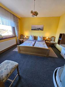 a bedroom with two beds and a large window at Thüringer Landhaus am Rennsteig in Gehlberg