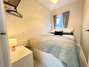 a bedroom with a bed with a laptop on it at Lovely spacious 3 double bed flat, LS17 in Leeds