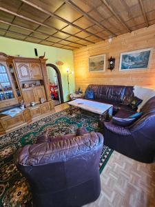 a living room with two couches and a table at Thüringer Landhaus am Rennsteig in Gehlberg