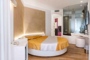 a bedroom with a large bed and a mirror at Hotel Exclusive in Agrigento