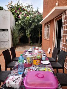 a table with food and drinks on a patio at Belle villa in Poponguine
