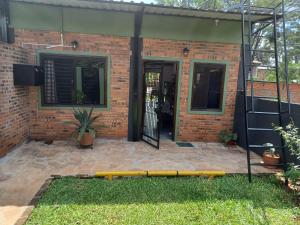 a yellow bench in front of a brick house at CASA Naranja.RR in Barrio San Isidro (2)