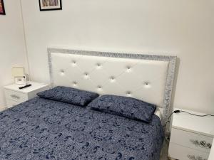 a bedroom with a bed with two pillows on it at Maison Elsa in San Vito Chietino