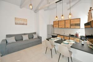 a living room with a couch and a table and chairs at Aori Guest House I in Hydra