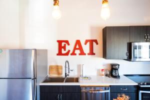 a kitchen with a sink and a cat sign on the wall at Lander Millhouse in Lander