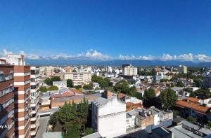 a city with buildings and mountains in the background at Apartho Dean Funes in Salta