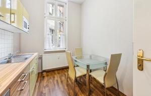 a kitchen with a table and chairs and a sink at 1 Bedroom Stunning Apartment In Anklam in Anklam
