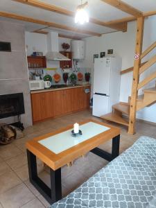 a living room with a table and a kitchen at Bieszczady111 - domki in Polańczyk