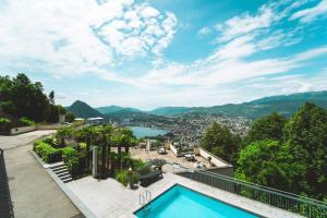 a villa with a swimming pool and a view at Tessa&Aurora - Incredible Lake View & Pool with Parking in Lugano