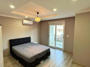 a bedroom with a bed in a room with a window at Peaceful Holiday Villas-Barbecue in Belek