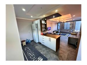 a kitchen with a refrigerator and a living room at Peaceful Holiday Villas-Barbecue in Belek