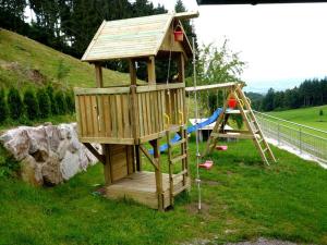 eine Holzspielstruktur mit einer Rutsche und einem Spielplatz in der Unterkunft Ferienhof Benz in Kappelrodeck
