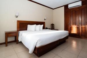 a bedroom with a large bed with white sheets at Hotel San Antonio in Tampico