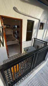 a balcony of a house with a table and a bench at CasaJuana Room Rental in Carles