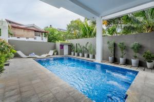 a swimming pool in the backyard of a house at Mzion Hotel Weligama in Weligama