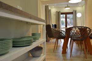 a room with plates and chairs and a table at Sevastie’s home in Samothraki