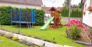 a backyard with a playground with a slide at Chalupa Kalameny in Kalameny