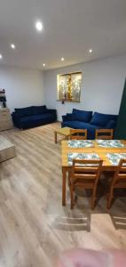 a living room with blue couches and a table at Apartament Luna in Karpacz