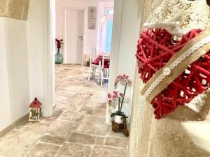 a hallway with a tile floor with a red heart on the wall at Antica Pietra in Polignano a Mare